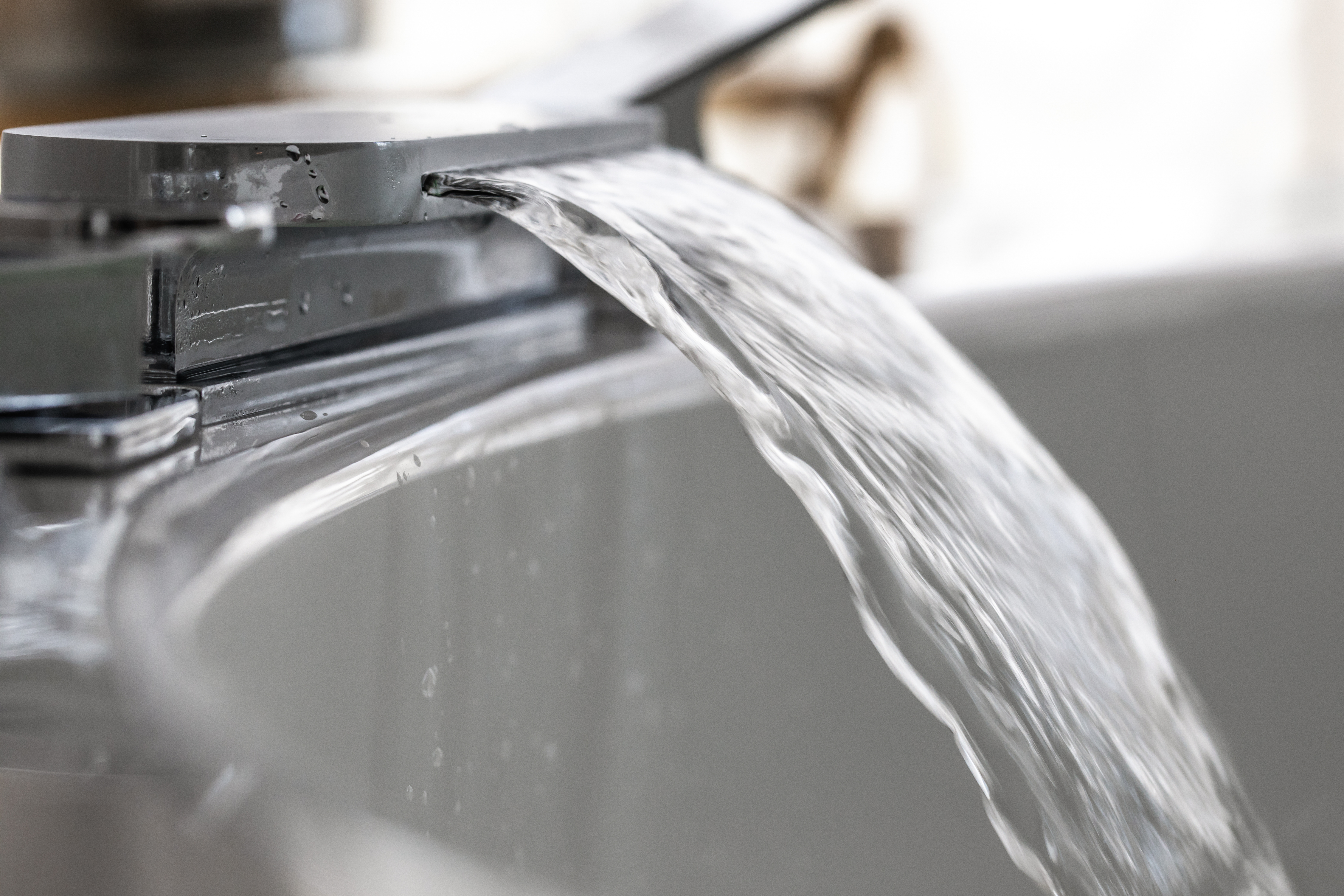 Spout running water from wide bath tub faucet into a hot  Jacuzzi bath, bathtub, running water, water supply 