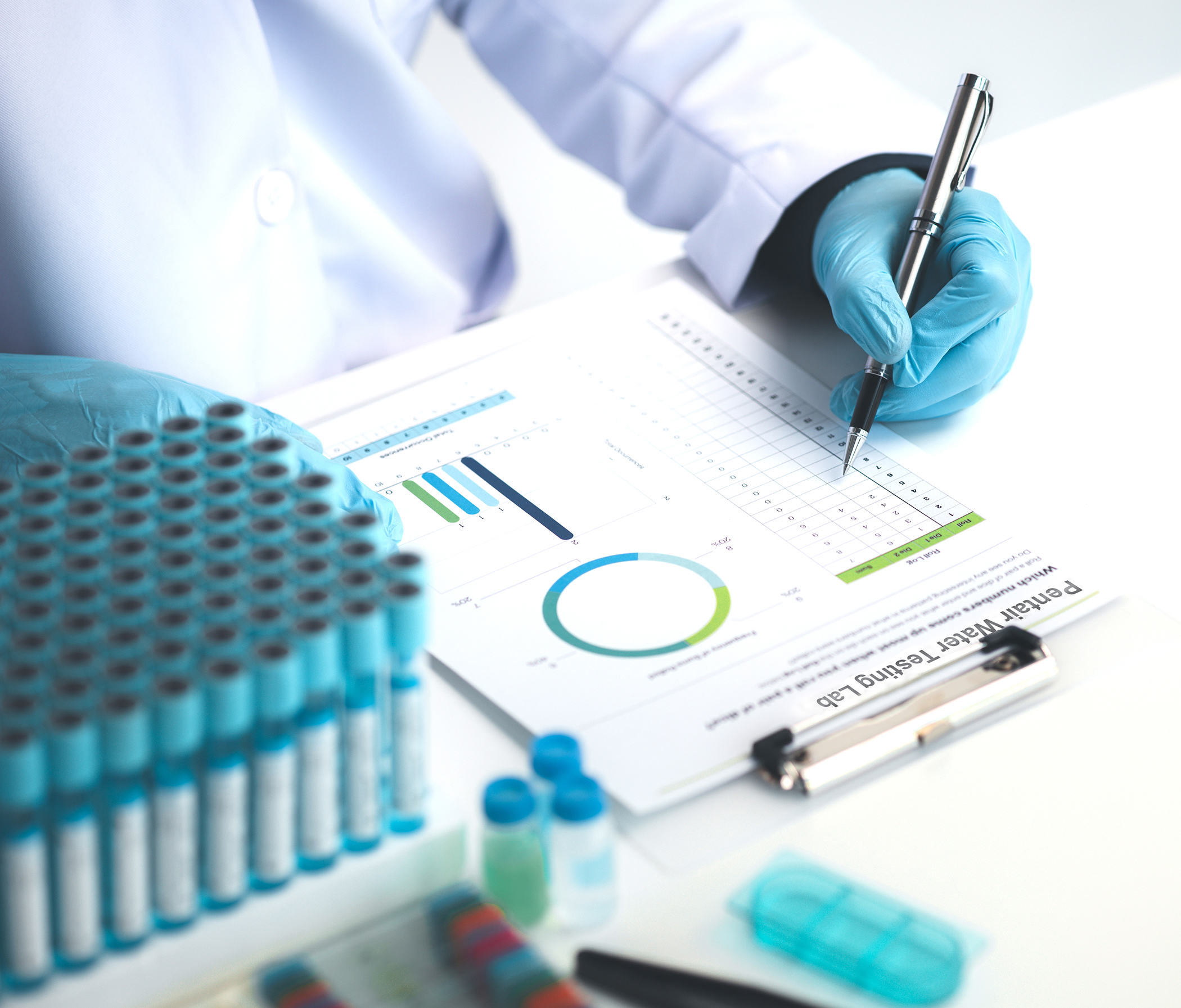 Lab assistant, medical scientist, chemistry researcher holds a glass tube through a chemical test tube, does a chemical experiment and examines a patient's sample. Medicine and research concept.; Shutterstock ID 2321871135; purchase_order: Water Testing Blow; job: 