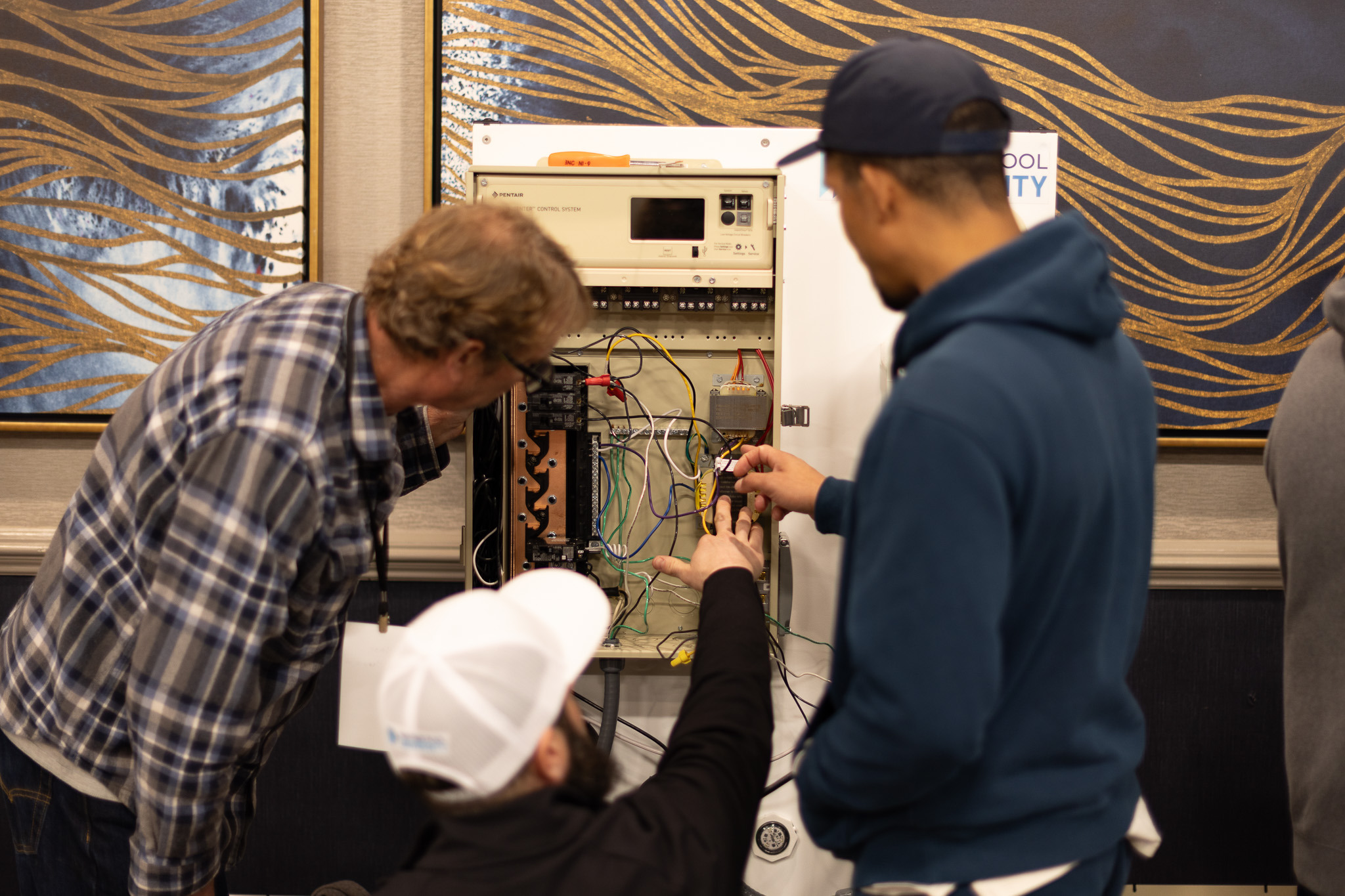 Three men working on an IntelliCenter